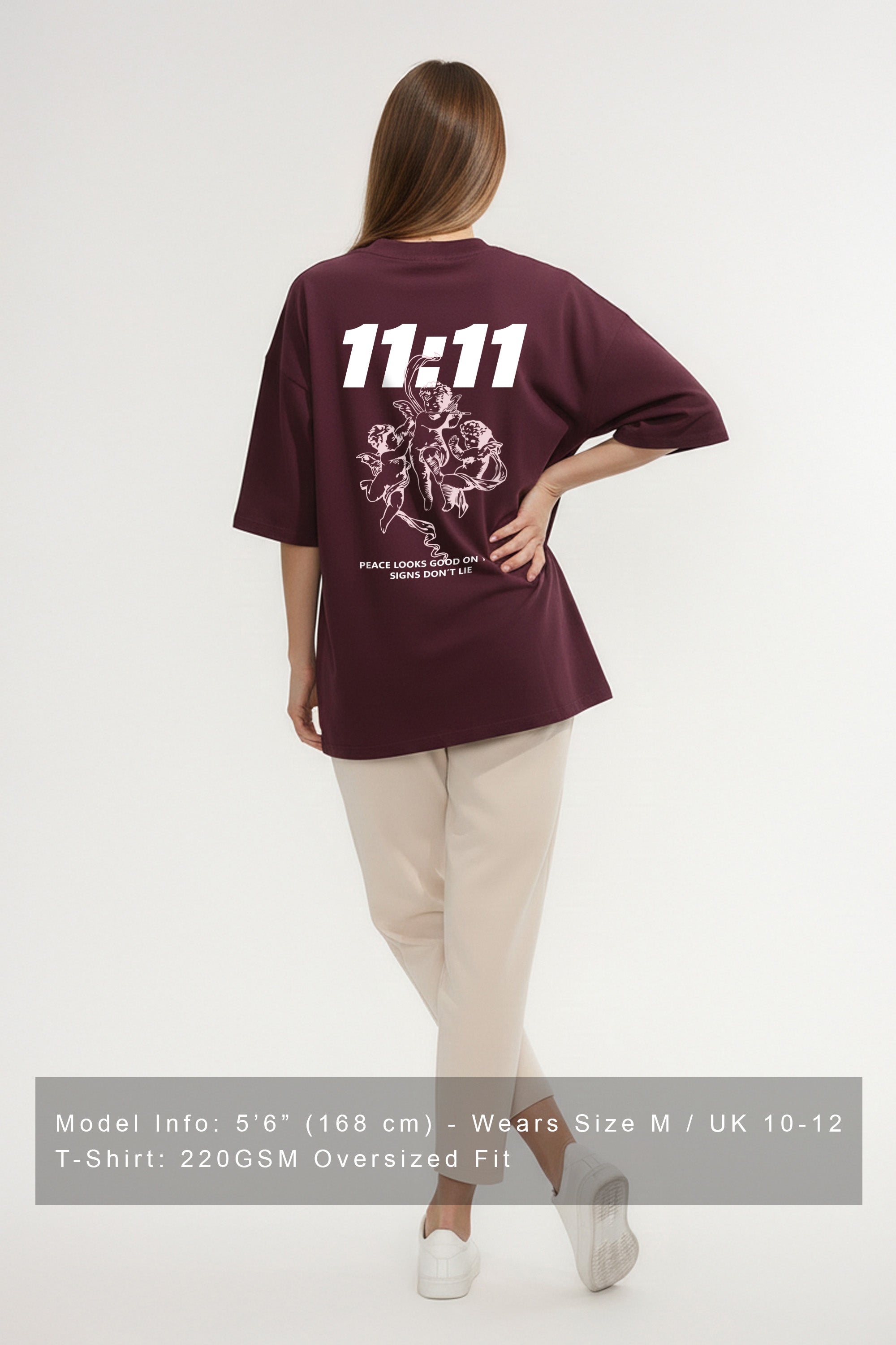 Dark cherry oversized 220GSM T-shirt with white 11:11 Peace Angel graphic on the back, model wearing size M